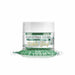 Christmas Green Tinker Dust edible glitter in a clear 5g jar with a white lid, spilled on a white surface.
