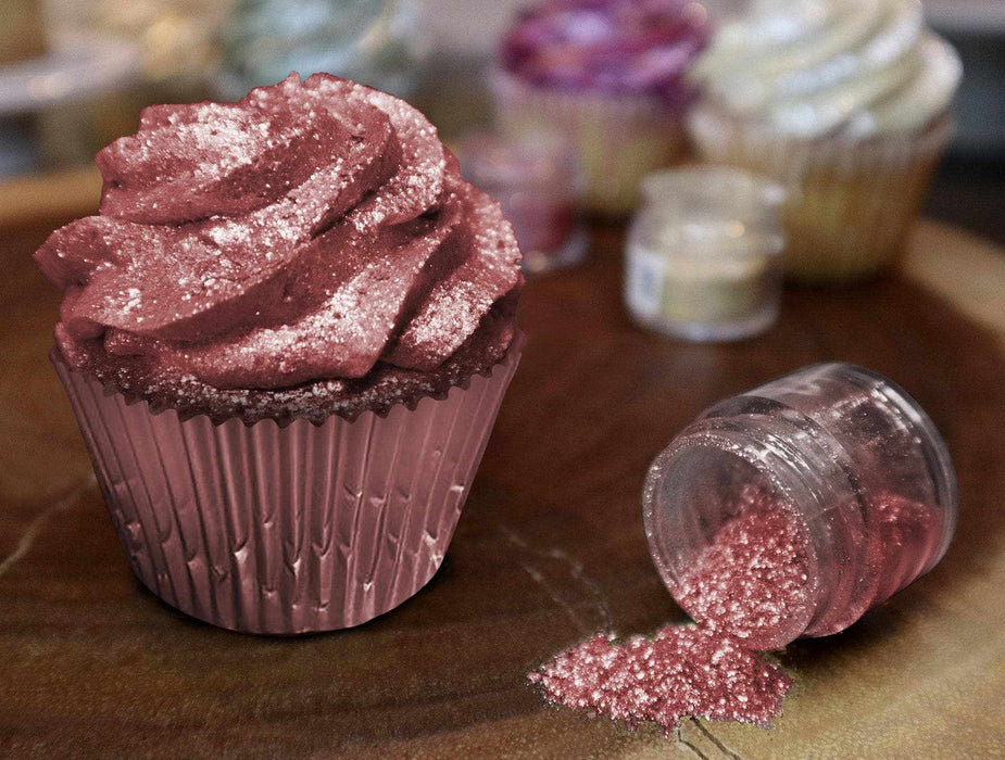 Red Tinker Dust edible glitter on a frosted cupcake and spilling from a small jar.