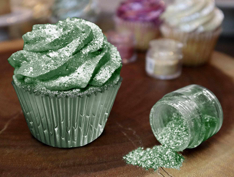 Green cupcake with edible Tinker Dust glitter, next to an open jar spilling green glitter.