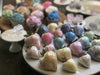 Assortment of glitter-dusted strawberries and cupcakes in various pastel colors, including pink, blue, and gold.