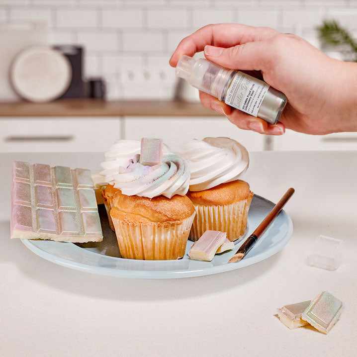 Three cupcakes and a wafer being sprayed by a Gold Iridescent color Luster Dust 4 gram pump. | bakell.com