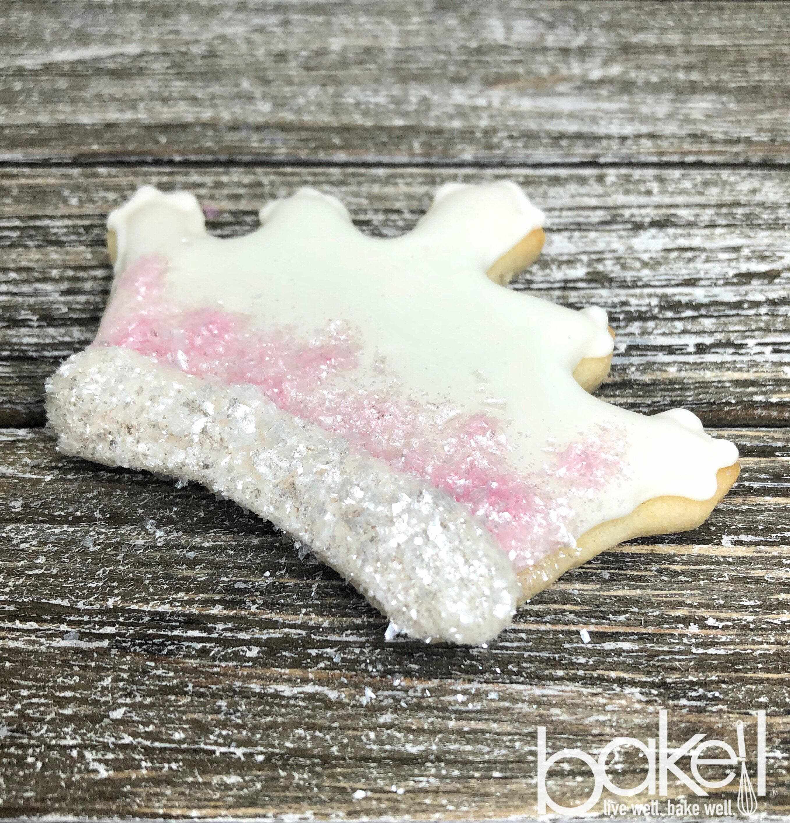 Ivory Tinker Dust® edible glitter on a white and pink frosted cookie.