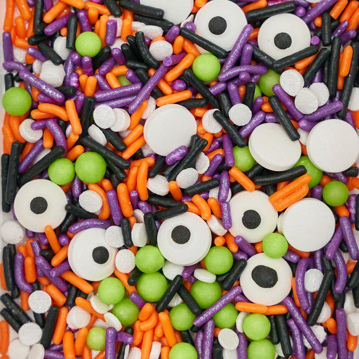Monster Mash sprinkles mix with white candy eyeballs, green spheres, and purple, orange, black, and white jimmies.