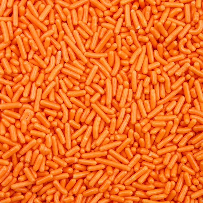 Bright orange jimmie sprinkles, a vibrant edible topping for desserts.