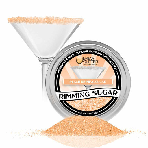 Front view:  To the left, a glass with its sugar rim covered in Peach Rimming Sugar , and to the right, a tin jar  of Peach Rimming Sugar, with spilled  sugar in front of it. | bakell.com