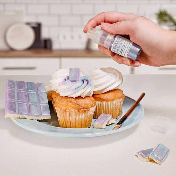 Three cupcakes and a wafer being sprayed by a Purple Iridescent color Luster Dust 4 gram pump. | bakell.com