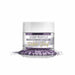 Deep Purple Tinker Dust edible glitter in a clear jar with white lid, spilled on a white surface.