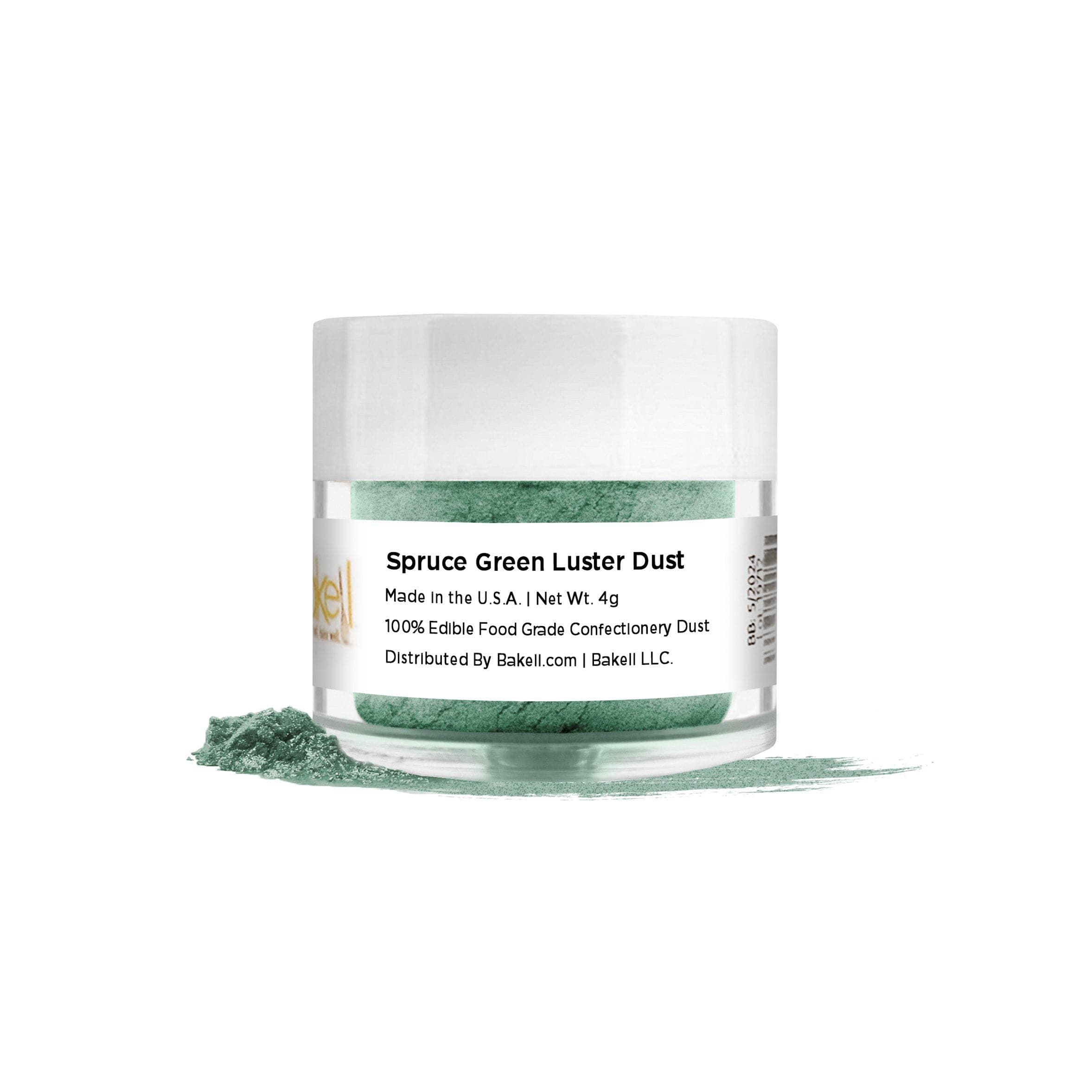Spruce Green Luster Dust in a clear jar with a white lid, spilled powder on a white surface.