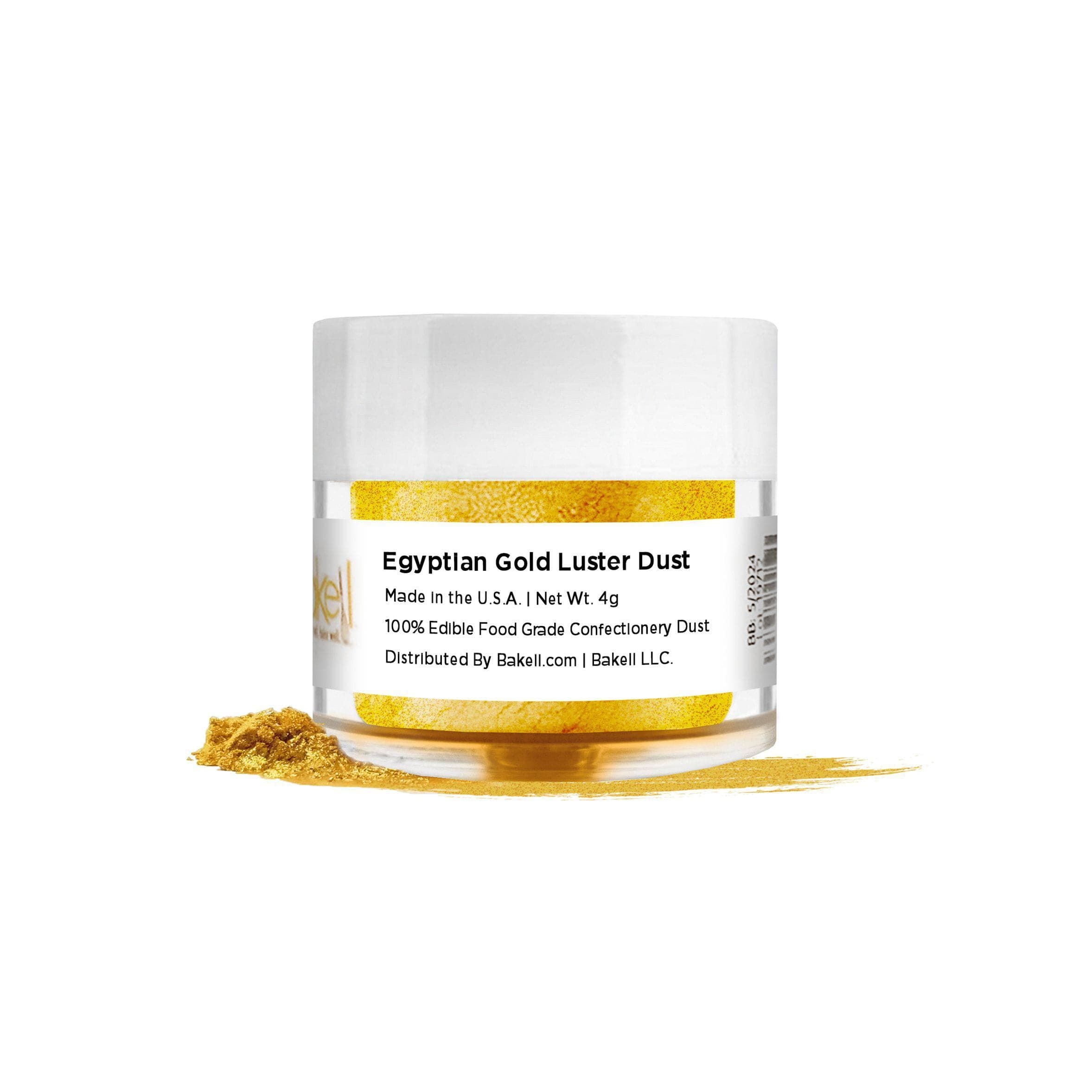 Egyptian Gold Luster Dust in a clear jar with a white lid, spilled on a white surface.
