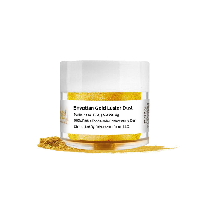Egyptian Gold Luster Dust in a clear jar with a white lid, spilled on a white surface.