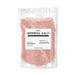 One pound bag of shimmering rose gold cocktail rimming salt with a white product label on a clear pouch.