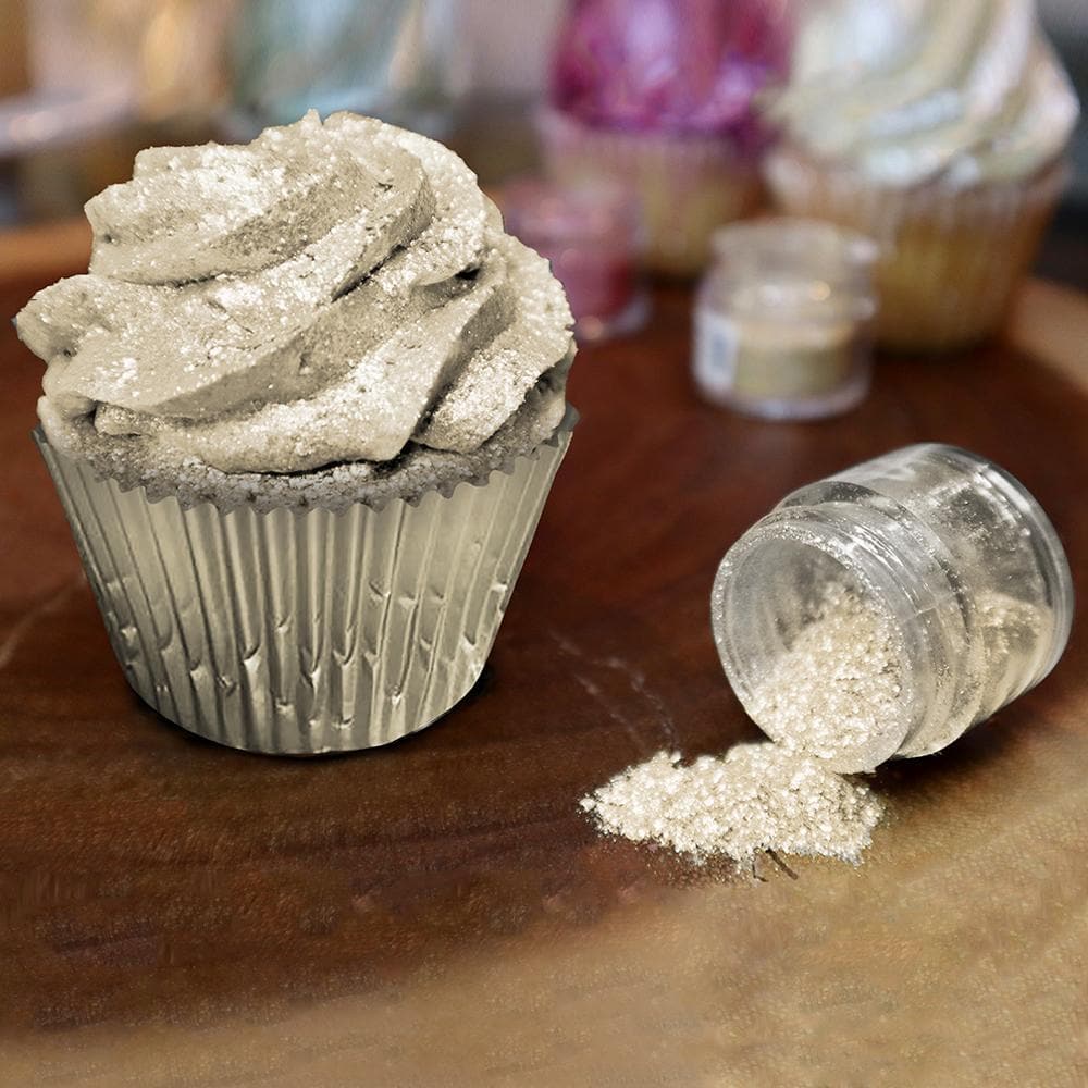 Champagne Gold Tinker Dust edible glitter sprinkled on a cupcake with a jar spilling more.