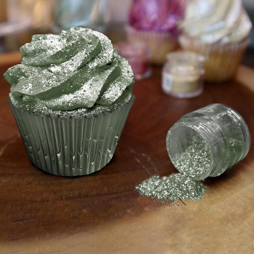 Olive Green Tinker Dust edible glitter sprinkled on a matching frosted cupcake with a spilled jar.